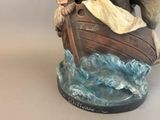 a figurine of a man and a woman in a boat