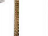 a gold bracelet that has a chain on it