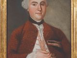 portrait of a man in a red coat holding a book