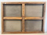 a close up of a wooden window with four panes of glass