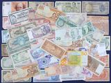 a lot of different foreign currency on the table