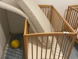 a baby crib that has a mattress in it