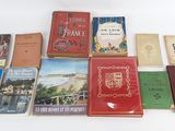 several books are arranged on a white surface with a white background