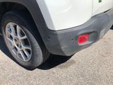 a close up of a white car parked in a parking lot