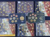 several different types of euro coins are displayed on a table