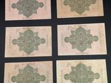 six different bank notes with different designs on them on a black surface