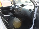 the interior of a small white car with the door open