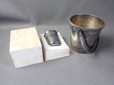 a silver bucket and a box with a cell phone in it