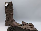 pair of brown leather boots on a white surface with a gray background