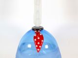 a blue vase with a red ribbon on top of it