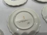 four plates with different designs on them sitting on a table