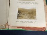 two pages of old books on display on a table