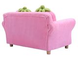 a pink couch with two stuffed animals on top of it