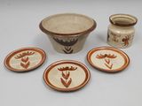 four plates and a bowl on the table