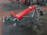 a red bench in the middle of a gym