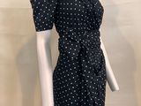 the mannequin is wearing a black dress with white polkas
