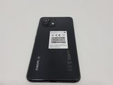 a close up of the back of a black phone with a sticker on it