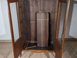 a wooden cabinet with a glass door on the floor