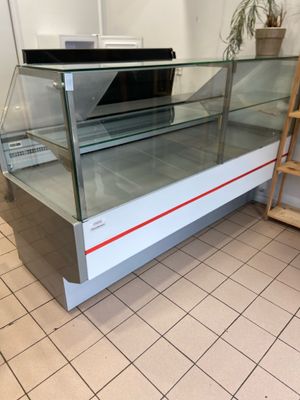 a glass display case with a laptop on top of it