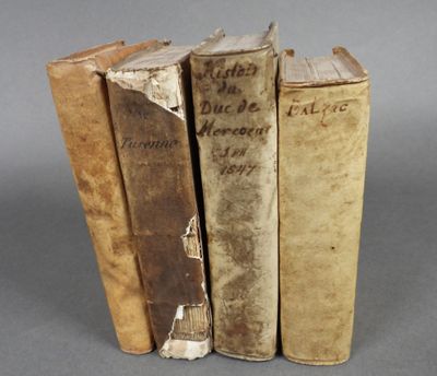 trois vieux livres posés l'un sur l'autre sur une table