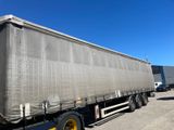 a large semi truck with a tarp on the back of it