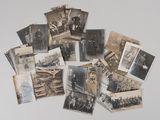 several old black and white photographs of men and women on a table