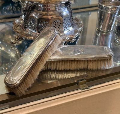 a brush and a brush holder on a glass table