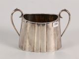 an image of a silver cup with a handle on a white surface