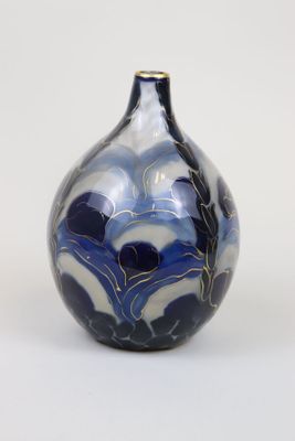a blue and white vase sitting on a white surface