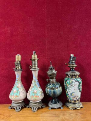 four vases sitting on a wooden table with a red wall in the background