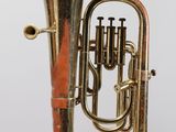 an old brass tuba is shown against a white background