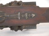 a close up of a gun on a white surface