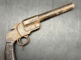 a close up of a gun on a metal surface