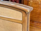 a bed with a wooden headboard and foot board in a room
