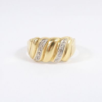 a close up of a gold and diamond ring on a white background