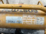 a close up of a yellow oil tank with a sticker on it