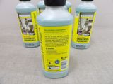 three bottles of cleaning products are sitting on a table
