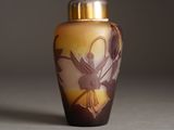a glass vase with a design on it sitting on a table