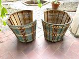two baskets that are sitting on a brick floor