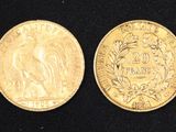 an image of two gold coins on a black surface