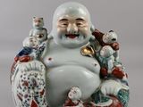 a figurine of a smiling man with a bunch of dolls