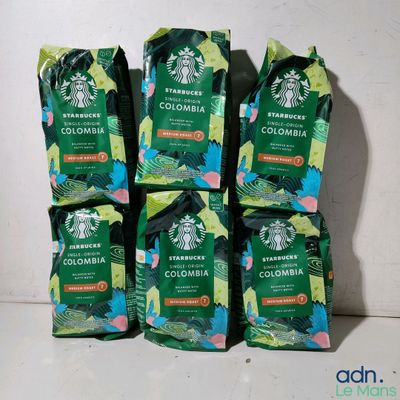 four bags of starbucks ' s colombia coffee sit on a counter