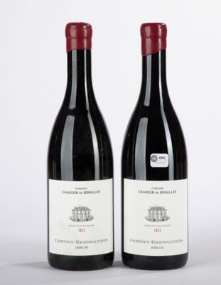 deux bouteilles de vin rouge posées l'une à côté de l'autre sur une surface blanche