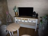 a small table with a tv on it in a living room