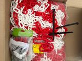 a cardboard box with a bunch of red and white items in it