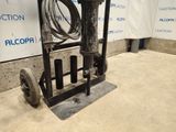 an image of a hand truck with a hose attached to it