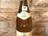 a bottle of wine sitting on a table in front of a brick wall