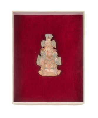une statue ancienne représentant une femme, dans un écrin de velours rouge