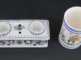 two cups and a box on a black surface