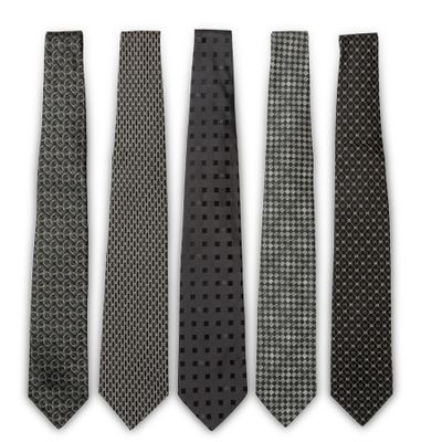four ties are lined up in a row on a white surface